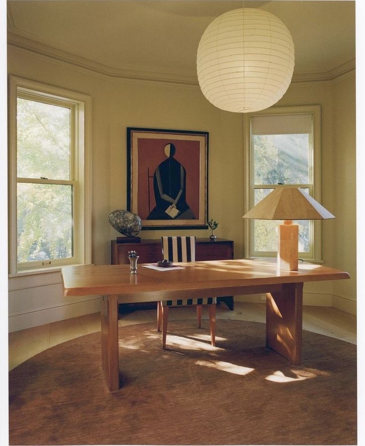 Alt Text - Bright home office with natural sunlight and ceiling lights illuminating the workspace.