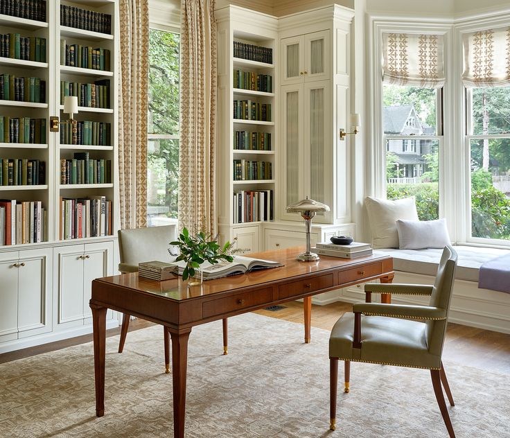 A well-designed home office with framed pictures, a lamp, and a comfortable chair